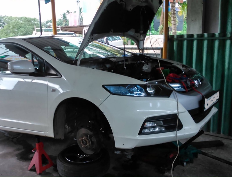 Honda hybrid vehicle repair on jack stands