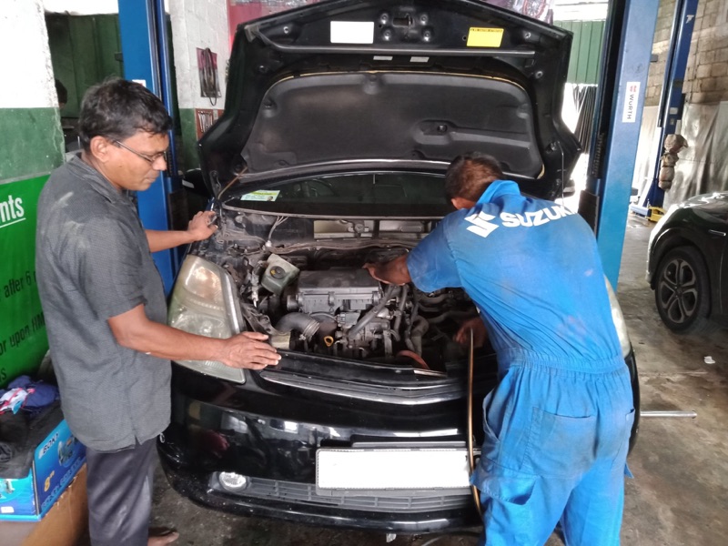 HACC staff inspecting hybrid engine
