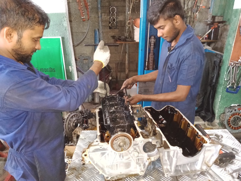 Mechanics team working on engine rebuild