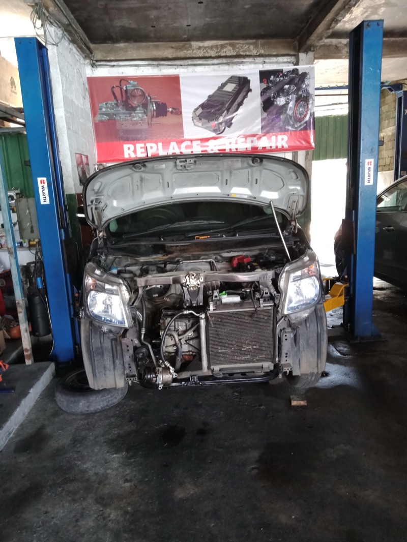 Vehicle on hydraulic lift for repair